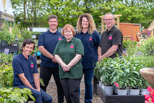 Five Cherry Lane members of staff smiling in a group outside in the garden centre