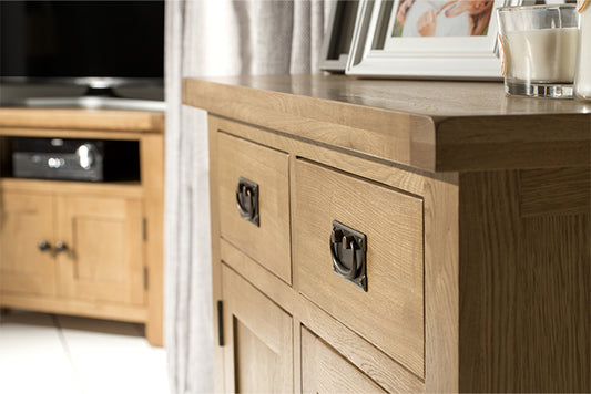 Up close of an oak sideboard in a living room from a side on angle