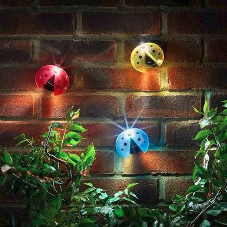 Ladybug solar lights attached to a brick wall