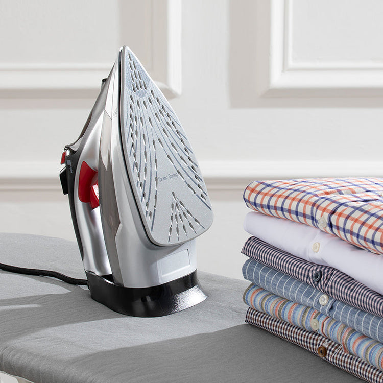 A kettle positioned alongside neatly folded tea towels