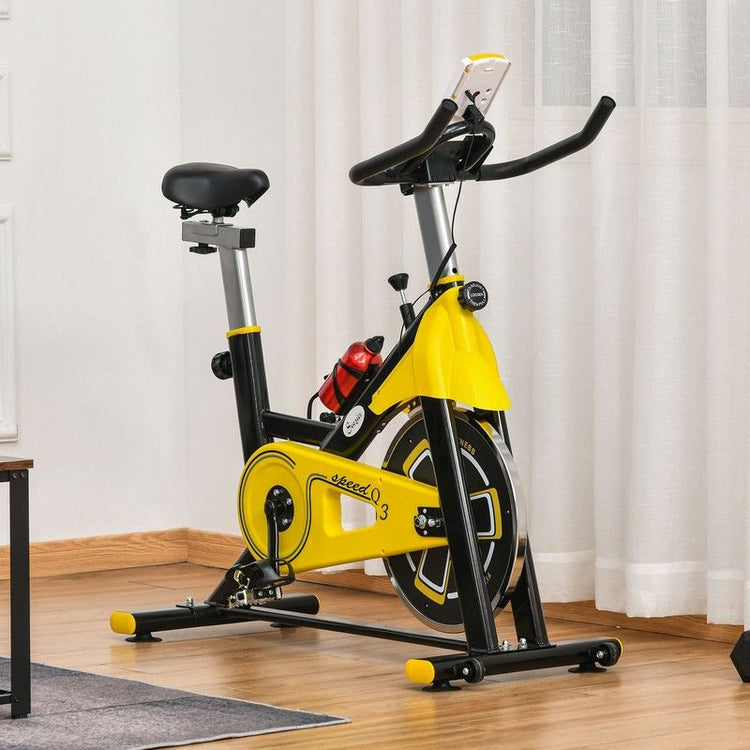 Exercise bike in colour yellow, standing in a living space