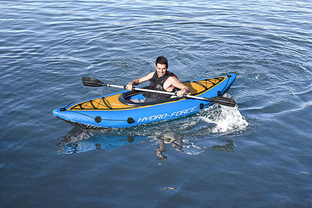 Adult man kayaking in deep water