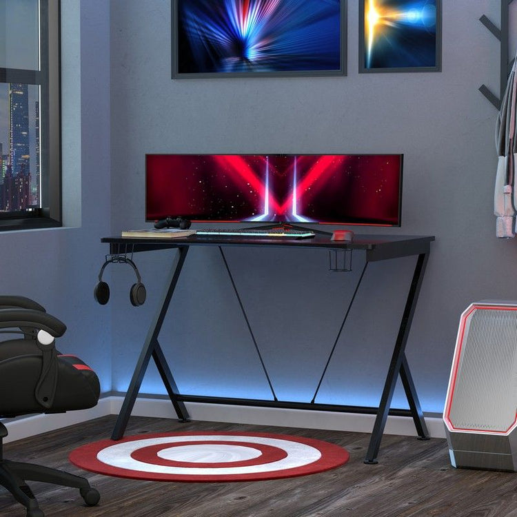 A gaming desk adorned with headphones and two monitors, creating an immersive setup