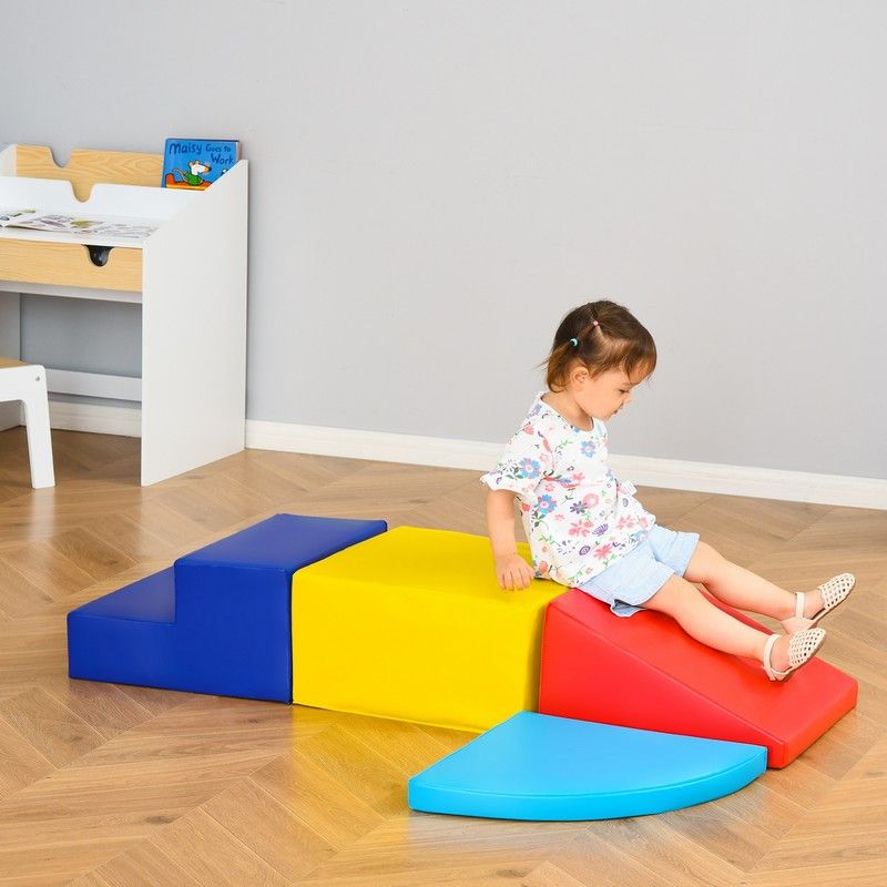 Toddler playing on a four piece soft play set