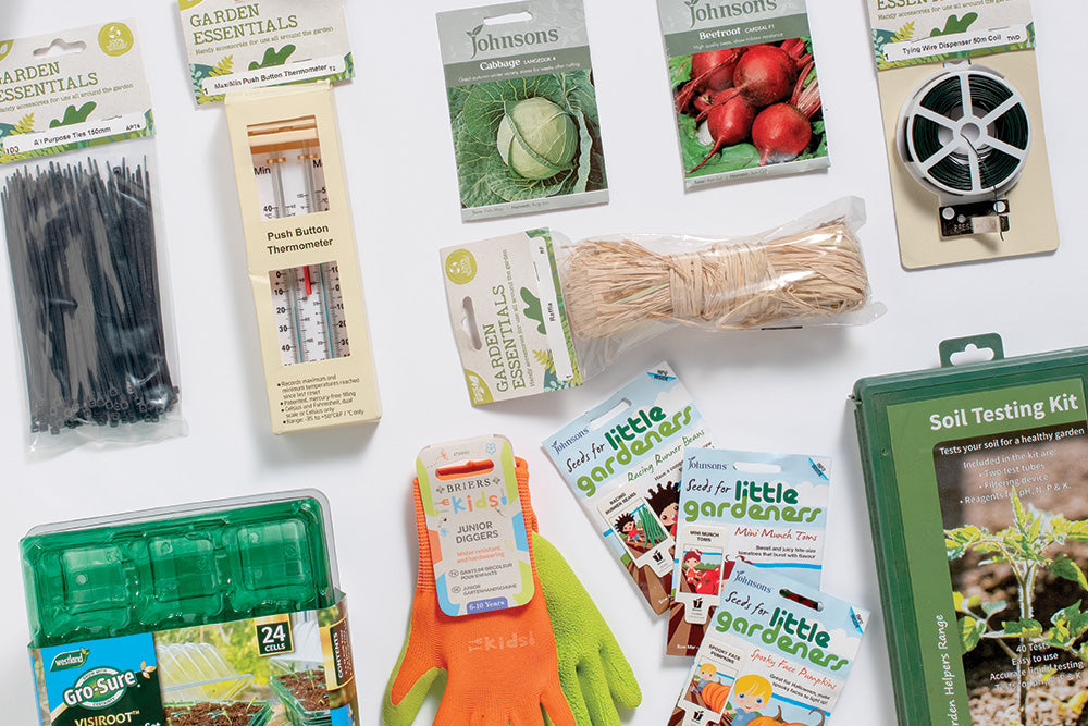 Various garden accessories and packets of seeds neatly arranged on a table