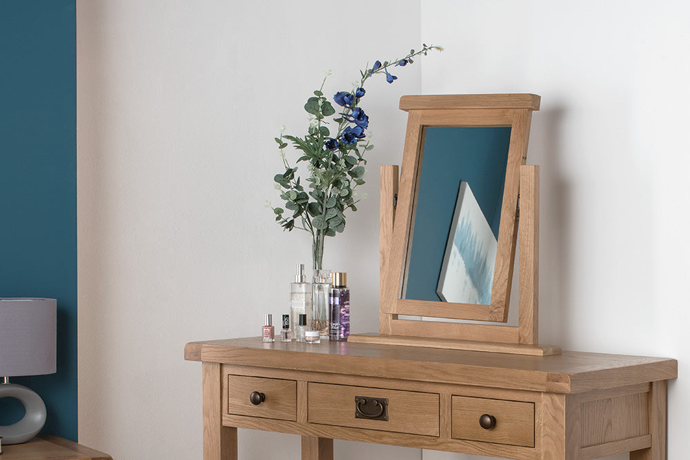 Wooden sideboard and matching mirror in a white room, adding to the neutral tones